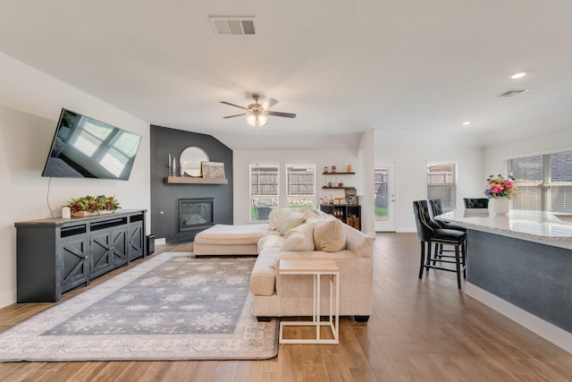 11225 Klondike Ln, Aubrey, TX 76227 - living room with wood finished floors, visible vents, a fireplace, and a ceiling fan
