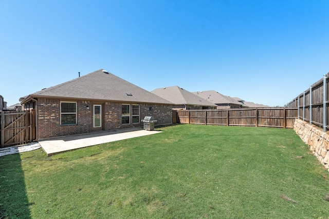 11225 Klondike Ln, Aubrey, TX 76227 - rear view of house with brick siding, a yard, a patio, a fenced backyard, and a shingled roof