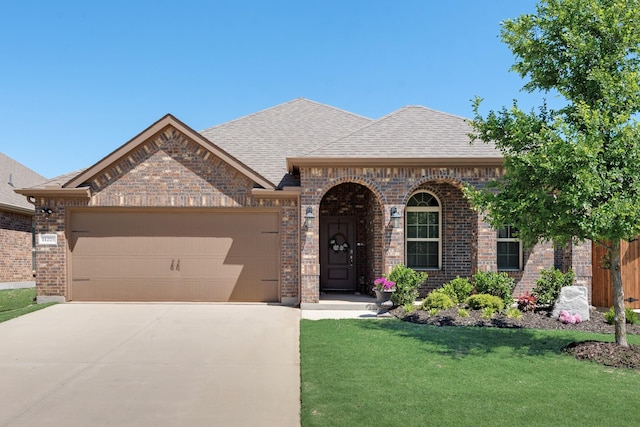 11225 Klondike Ln, Aubrey, TX 76227 - french provincial home featuring driveway, brick siding, a garage, a shingled roof, and a front yard