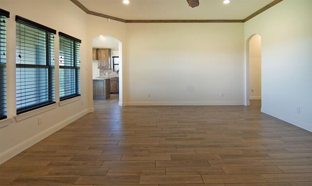 217 Timber Valley Ct, Weatherford, TX 76085 - unfurnished room with arched walkways, crown molding, dark wood-style floors, baseboards, and recessed lighting