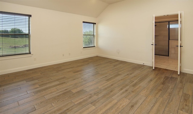 217 Timber Valley Ct, Weatherford, TX 76085 - spare room featuring lofted ceiling, wood finished floors, and baseboards