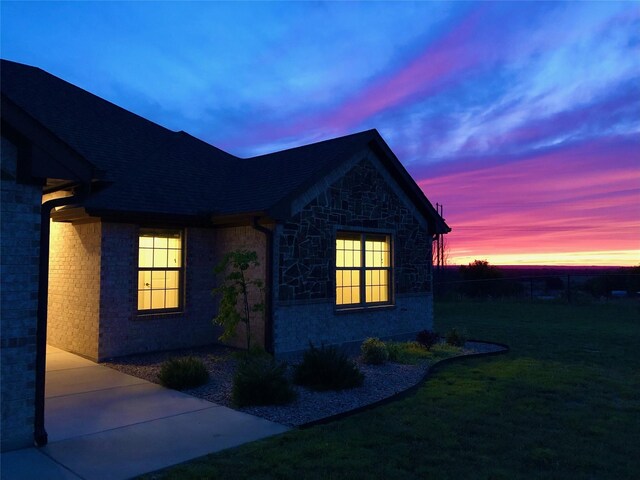 217 Timber Valley Ct, Weatherford, TX 76085 - view of side of home with a yard, stone siding, and brick siding