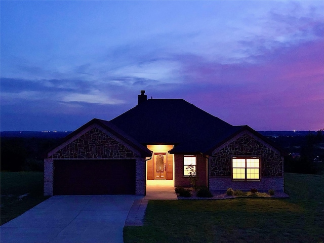 217 Timber Valley Ct, Weatherford, TX 76085 - french country style house featuring an attached garage, concrete driveway, a chimney, a yard, and stone siding