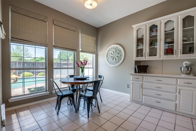 dining area featuring baseboards, a wealth of natural light, and light tile patterned floors