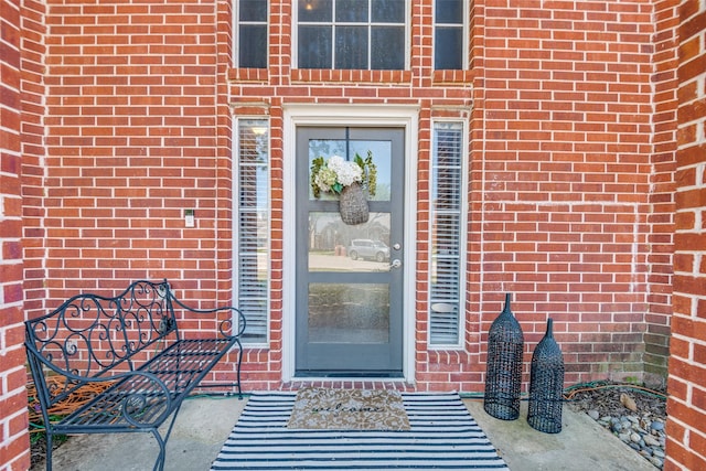 property entrance with brick siding