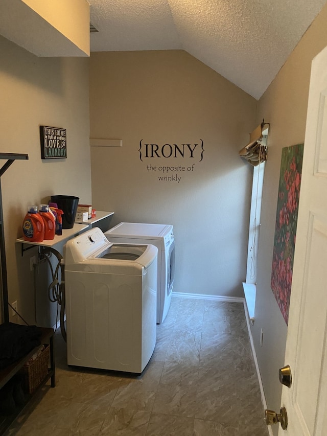 laundry area with baseboards, a textured ceiling, laundry area, and independent washer and dryer