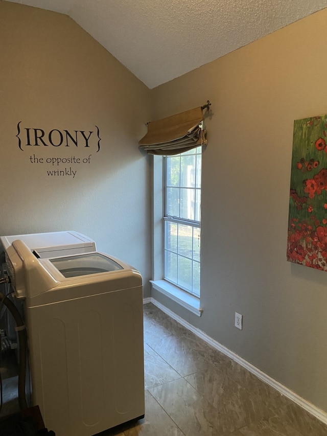 laundry area featuring a textured ceiling, separate washer and dryer, marble finish floor, baseboards, and laundry area