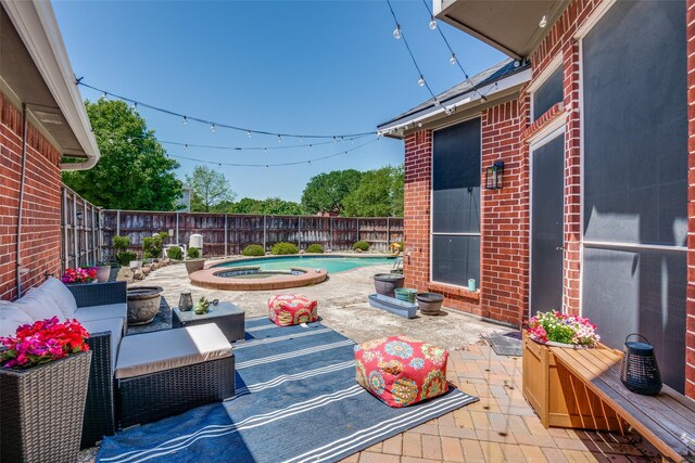 view of patio / terrace with outdoor lounge area, a fenced in pool, a fenced backyard, and an in ground hot tub