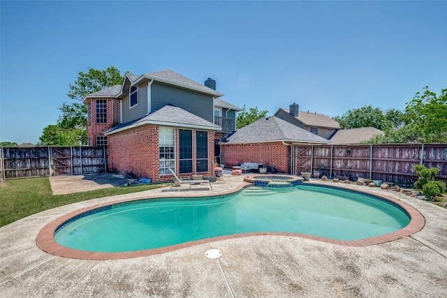 view of pool with a fenced backyard, a patio area, and a pool with connected hot tub