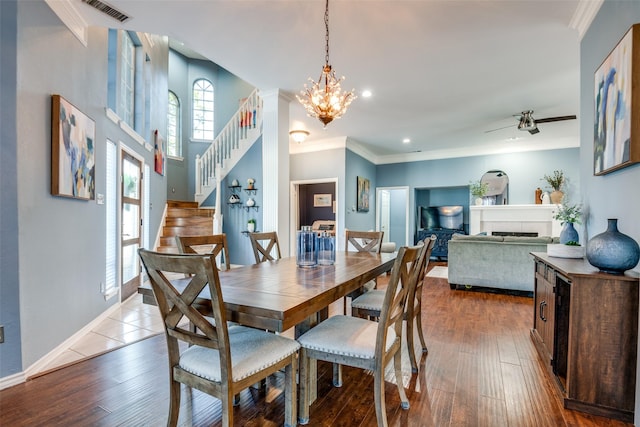dining area with baseboards, visible vents, an inviting chandelier, stairs, and ornamental molding