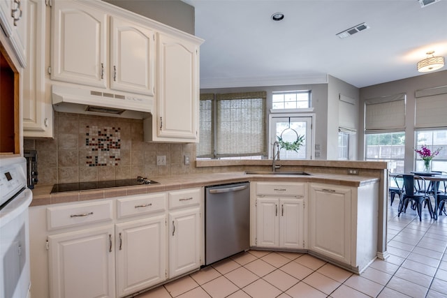 kitchen with a sink, dishwasher, black electric cooktop, a peninsula, and under cabinet range hood