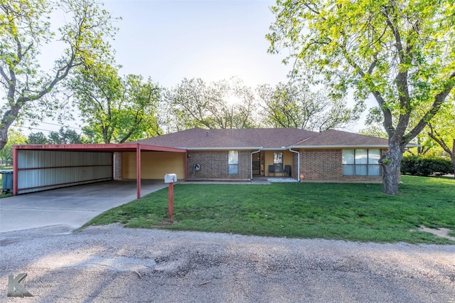 ranch-style house with brick siding, an attached carport, driveway, and a front yard