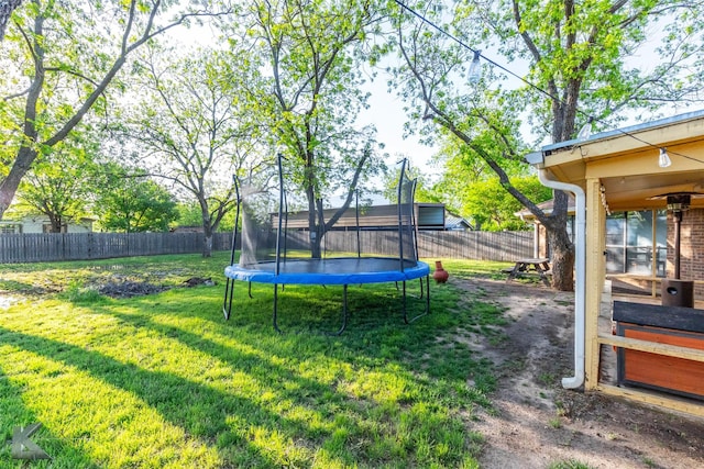 view of yard featuring a fenced backyard and a trampoline