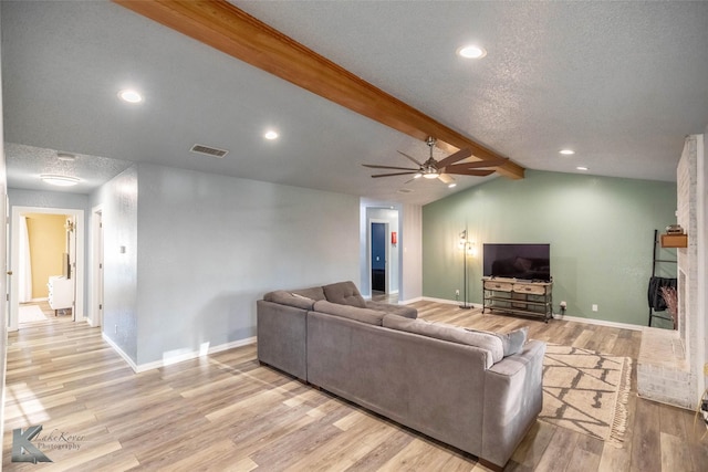 living area with lofted ceiling with beams, baseboards, visible vents, a ceiling fan, and wood finished floors