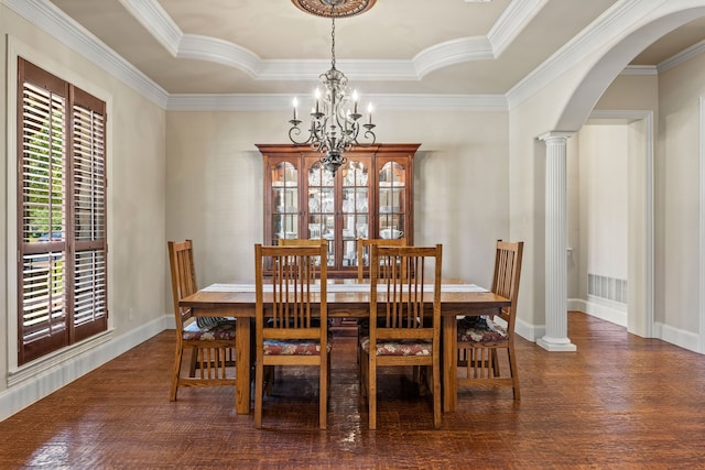 dining area featuring a raised ceiling, wood finished floors, arched walkways, crown molding, and a notable chandelier