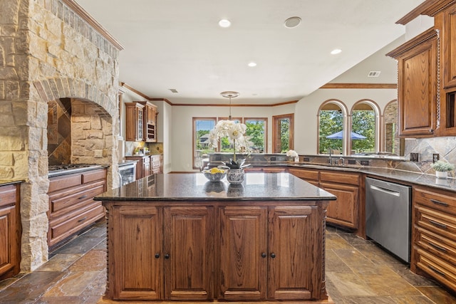 kitchen with stone tile floors, stainless steel dishwasher, a sink, and ornamental molding