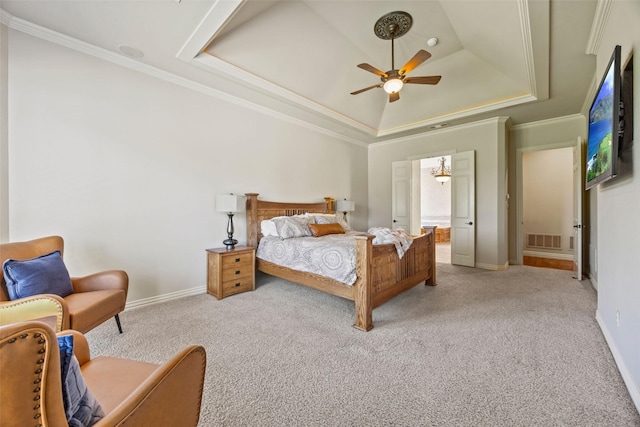 bedroom with light carpet, a tray ceiling, visible vents, and baseboards