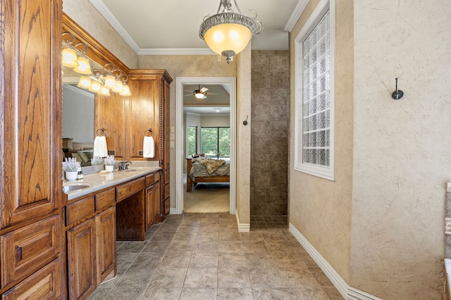bathroom featuring double vanity, a ceiling fan, stone finish flooring, ensuite bath, and crown molding