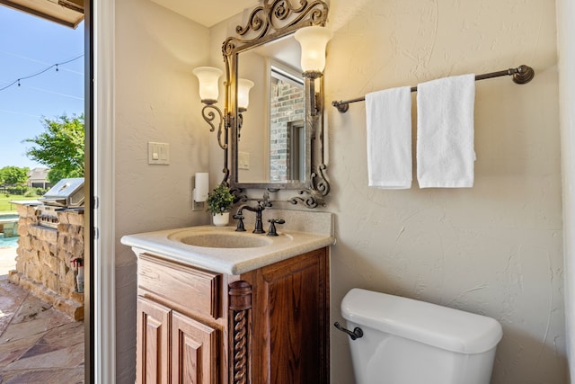 bathroom with toilet and vanity