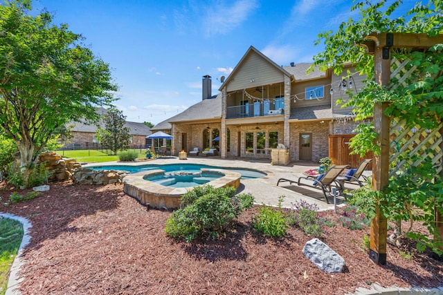 view of pool with a patio area, fence, a ceiling fan, and a pool with connected hot tub