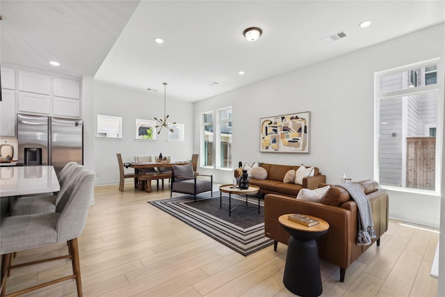 13361 Hedgebrook Pl, Fort Worth, TX 76008 - living room featuring a chandelier, light wood finished floors, recessed lighting, and baseboards