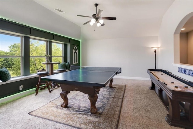 playroom featuring lofted ceiling, visible vents, arched walkways, carpet floors, and ceiling fan