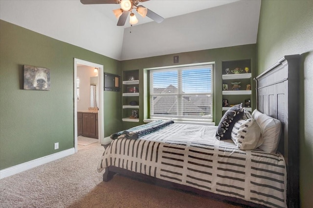 bedroom featuring carpet flooring, baseboards, ceiling fan, ensuite bath, and high vaulted ceiling