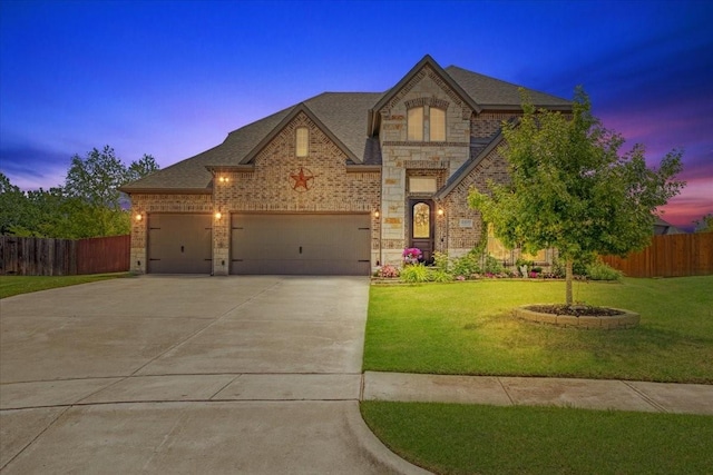 french country home with fence, driveway, and a yard