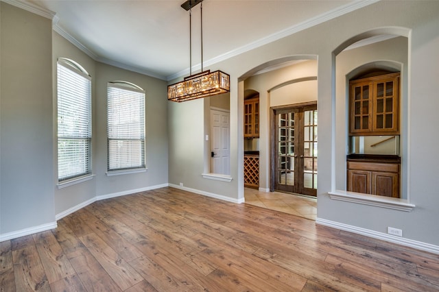 103 Lakehill Ct, Hickory Creek, TX 75065 - empty room featuring wood-type flooring, french doors, crown molding, baseboards, and arched walkways