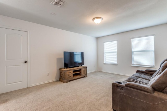 living room with light carpet, baseboards, and visible vents