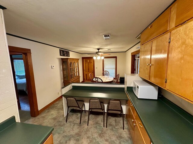 recreation room featuring baseboards, a ceiling fan, and visible vents