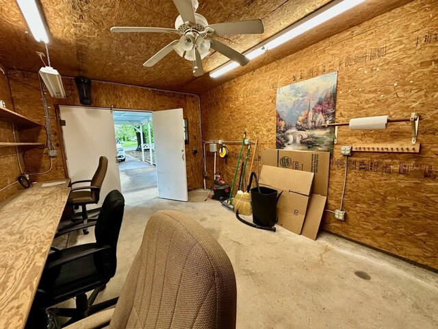 office space with a ceiling fan and unfinished concrete floors