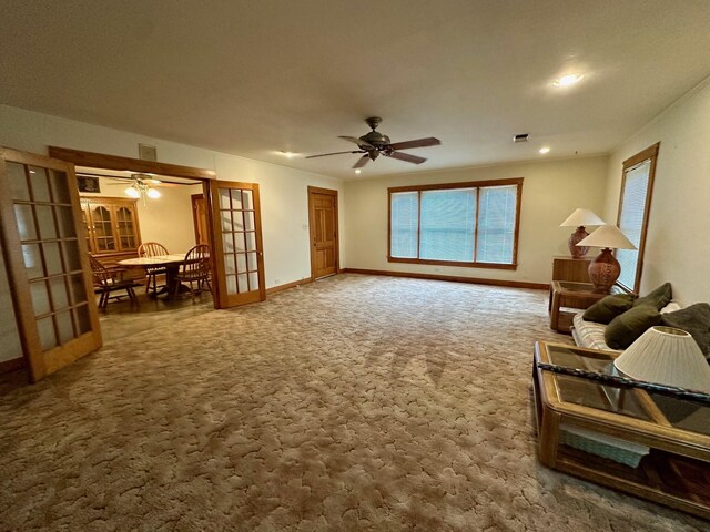 living area with recessed lighting, dark colored carpet, baseboards, and ceiling fan