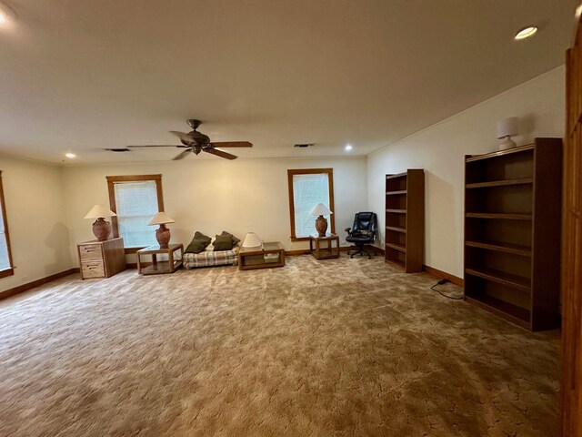 living area with baseboards, dark carpet, and recessed lighting