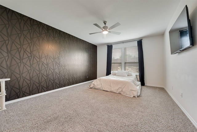 carpeted bedroom featuring baseboards and ceiling fan