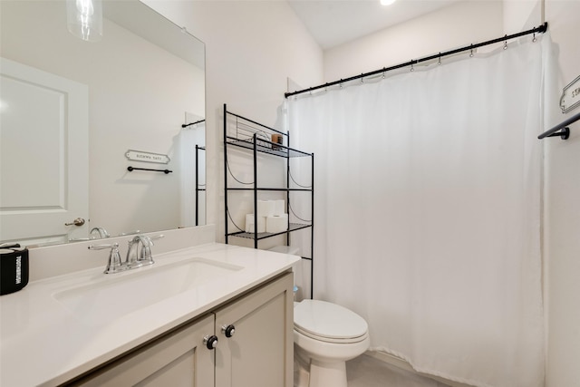 bathroom featuring vanity, curtained shower, and toilet