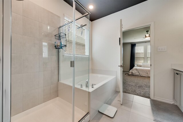bathroom featuring a shower stall, tile patterned flooring, ensuite bath, a garden tub, and ceiling fan