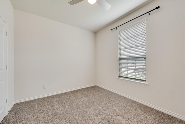 spare room featuring carpet, baseboards, and ceiling fan