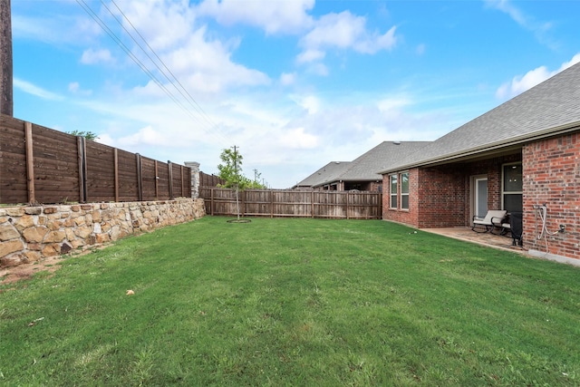 view of yard with a fenced backyard
