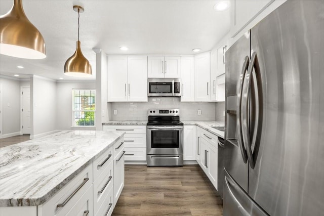 kitchen with white cabinets, dark wood-style flooring, decorative backsplash, and stainless steel appliances