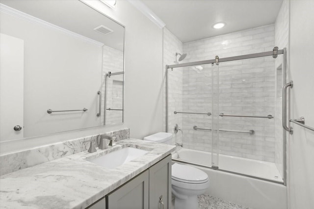 bathroom with enclosed tub / shower combo, visible vents, toilet, vanity, and crown molding