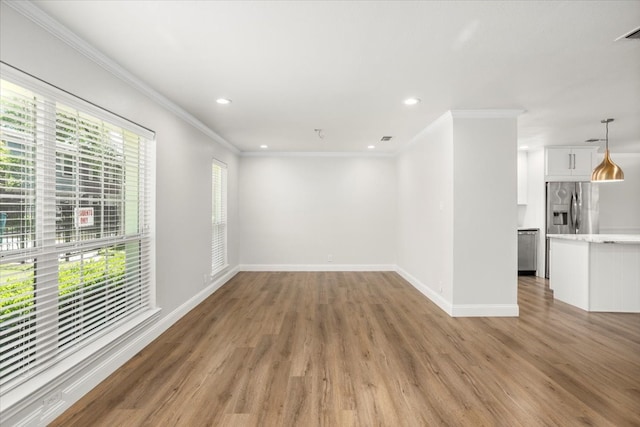 unfurnished living room with light wood-style flooring, baseboards, recessed lighting, and crown molding