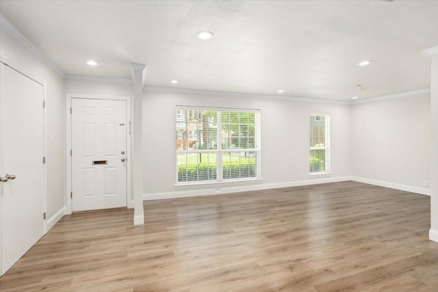 interior space with recessed lighting, light wood finished floors, crown molding, and baseboards