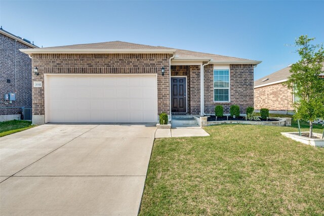 ranch-style home featuring an attached garage, brick siding, driveway, and a front yard