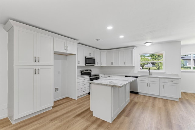 7009 Overhill Rd, Fort Worth, TX 76116 - kitchen featuring white cabinets, light wood-style flooring, visible vents, and appliances with stainless steel finishes