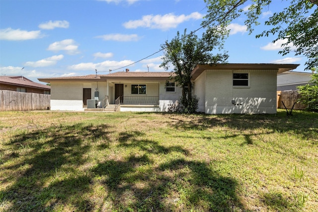 7009 Overhill Rd, Fort Worth, TX 76116 - rear view of house featuring brick siding, fence, a yard, and covered porch