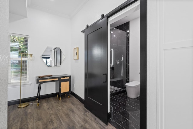bathroom with a shower stall, toilet, baseboards, and ornamental molding