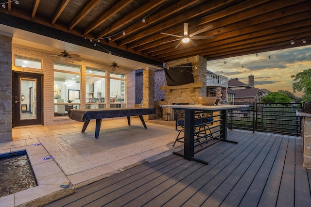 wooden deck with a ceiling fan and outdoor dry bar