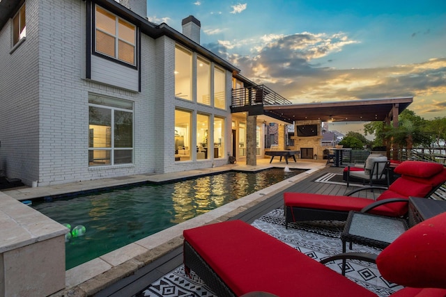 exterior space with an outdoor stone fireplace and a patio area