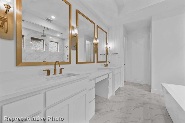 full bath with double vanity, a freestanding tub, a marble finish shower, and a sink